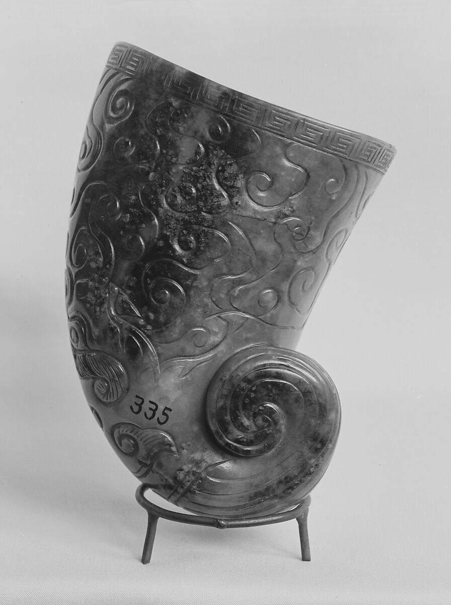 Horn-Shaped Cup, Nephrite, light sage-green mottled with lighter spots and stained and encrusted in part with patches of dead-oak-leaf, China 