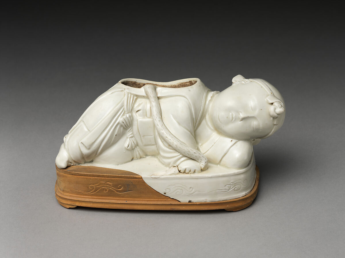 Base of a pillow in the form of a boy, Porcelain with ivory white glaze (Ding ware), China 