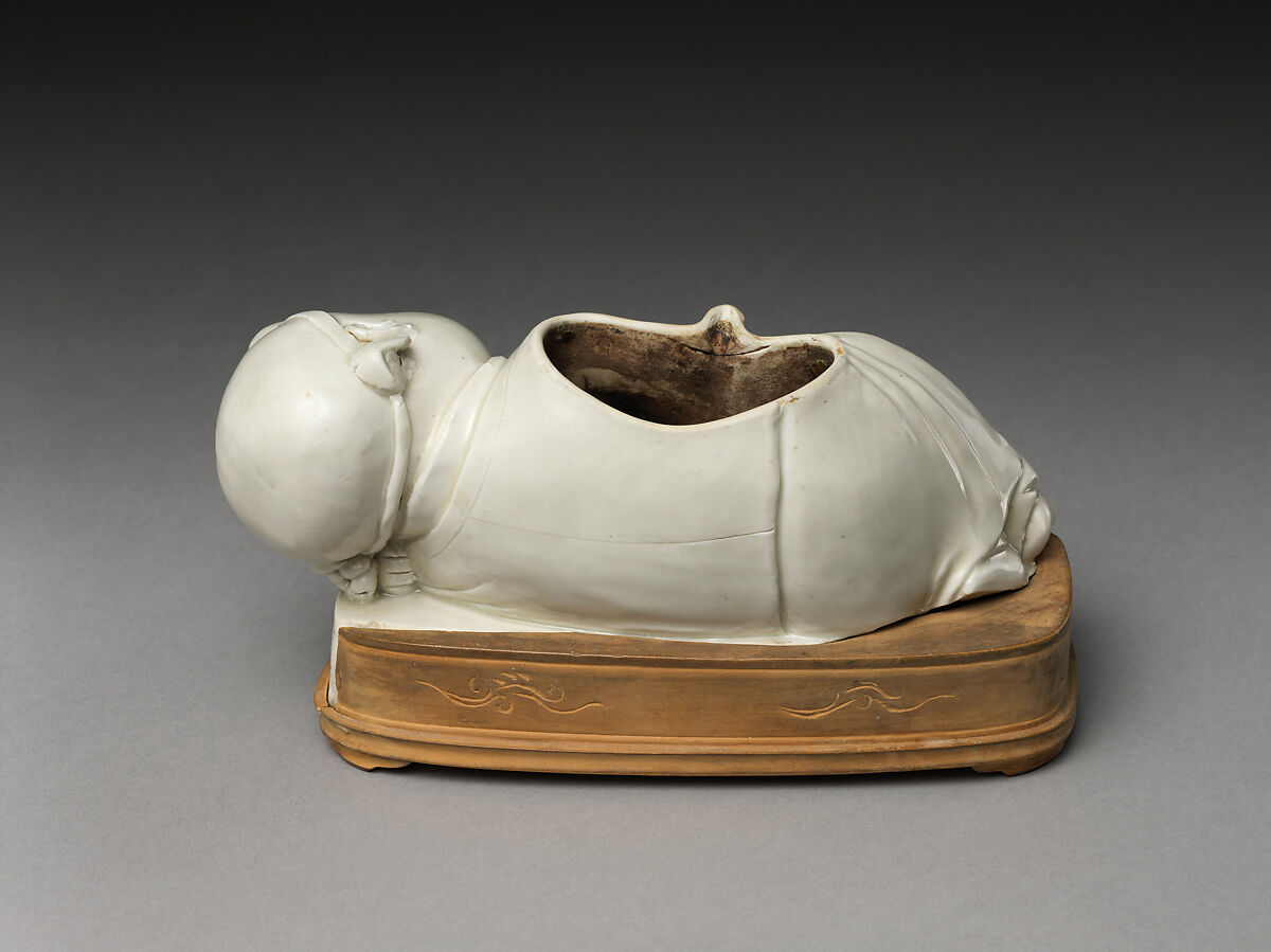 Base of a pillow in the form of a boy, Porcelain with ivory white glaze (Ding ware), China