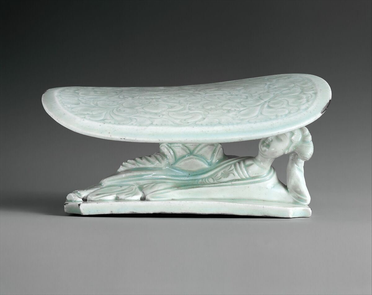 Pillow in Shape of Reclining Woman

, Porcelain with incised and carved decoration under celadon glaze (Jingdezhen Qingbai ware), China