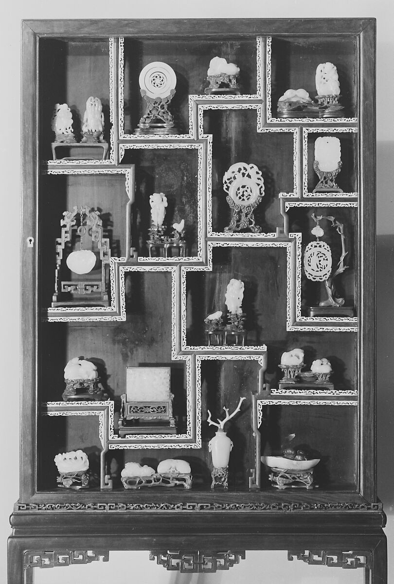 Vitrine Containing Twenty-Three Ornaments, a-w:Jade and other materials; x: wood vitrine with strips of ivory fret, China 