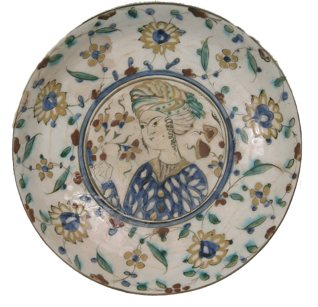 Plate, Stonepaste; underglaze painted in black, blue, and green with red and yellow slips 