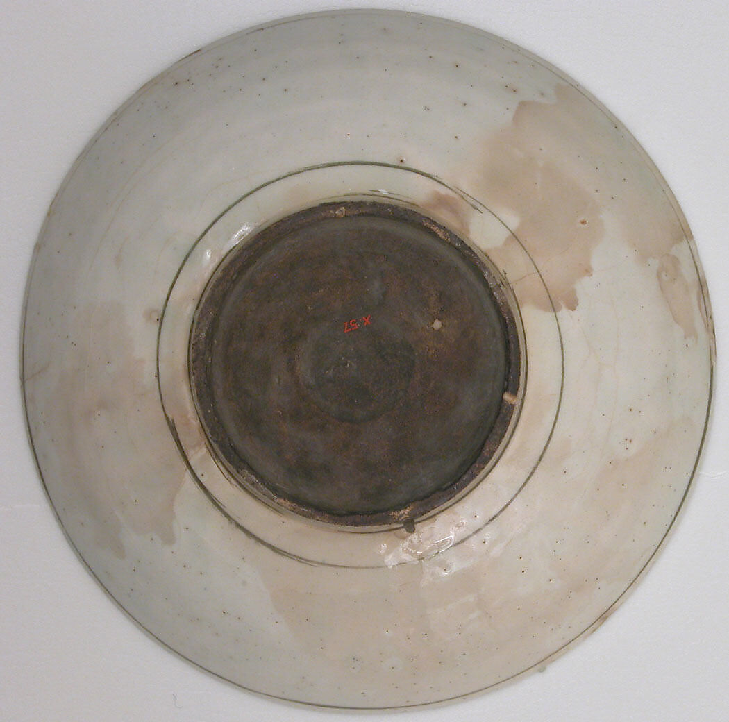 Plate, Stonepaste; underglaze painted in black, blue, and green with red and yellow slips