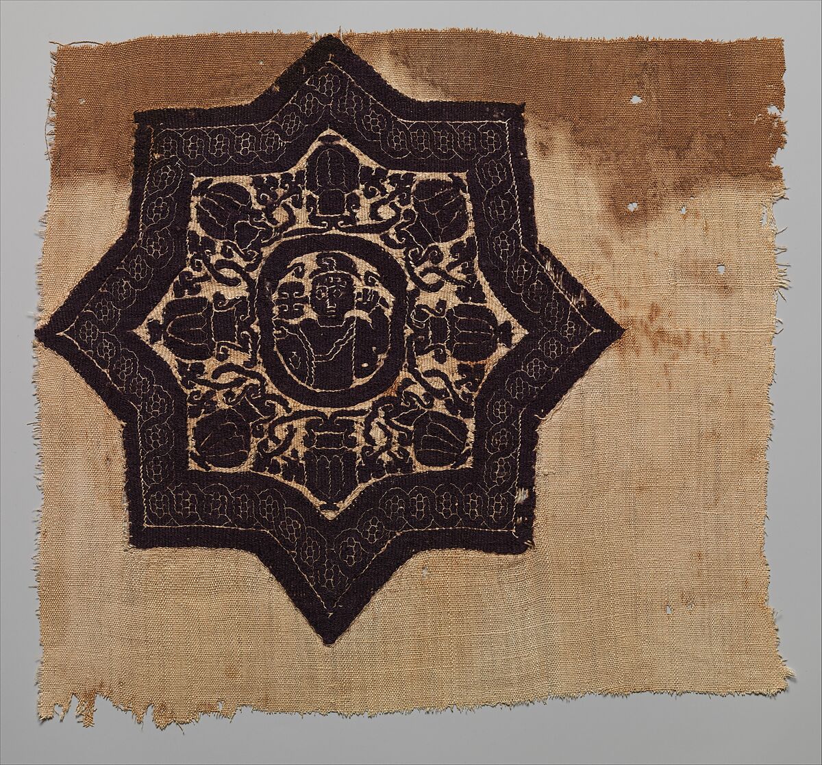 Fragment with an Eight-Pointed Star Containing a Warrior, Wool, linen; plain weave, tapestry weave 