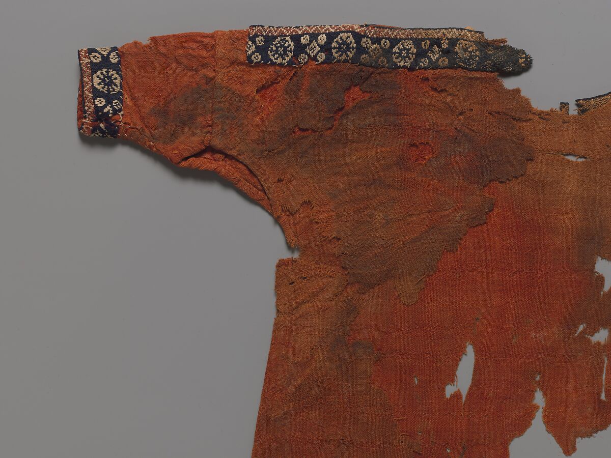 Child's Dress, Plain weave in red wool (dyed with madder); applied borders with pattern weft in blue and red wool and undyed linen