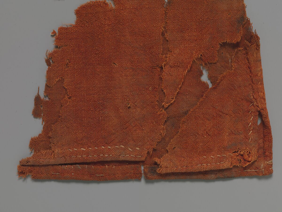 Child's Dress, Plain weave in red wool (dyed with madder); applied borders with pattern weft in blue and red wool and undyed linen