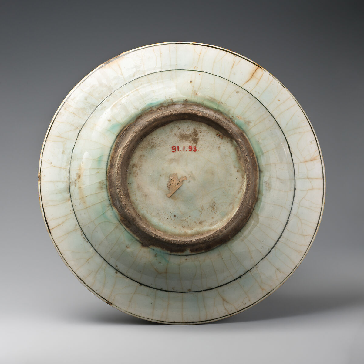 Dish, Stonepaste; underglaze painted in black, blue, and green with red slip