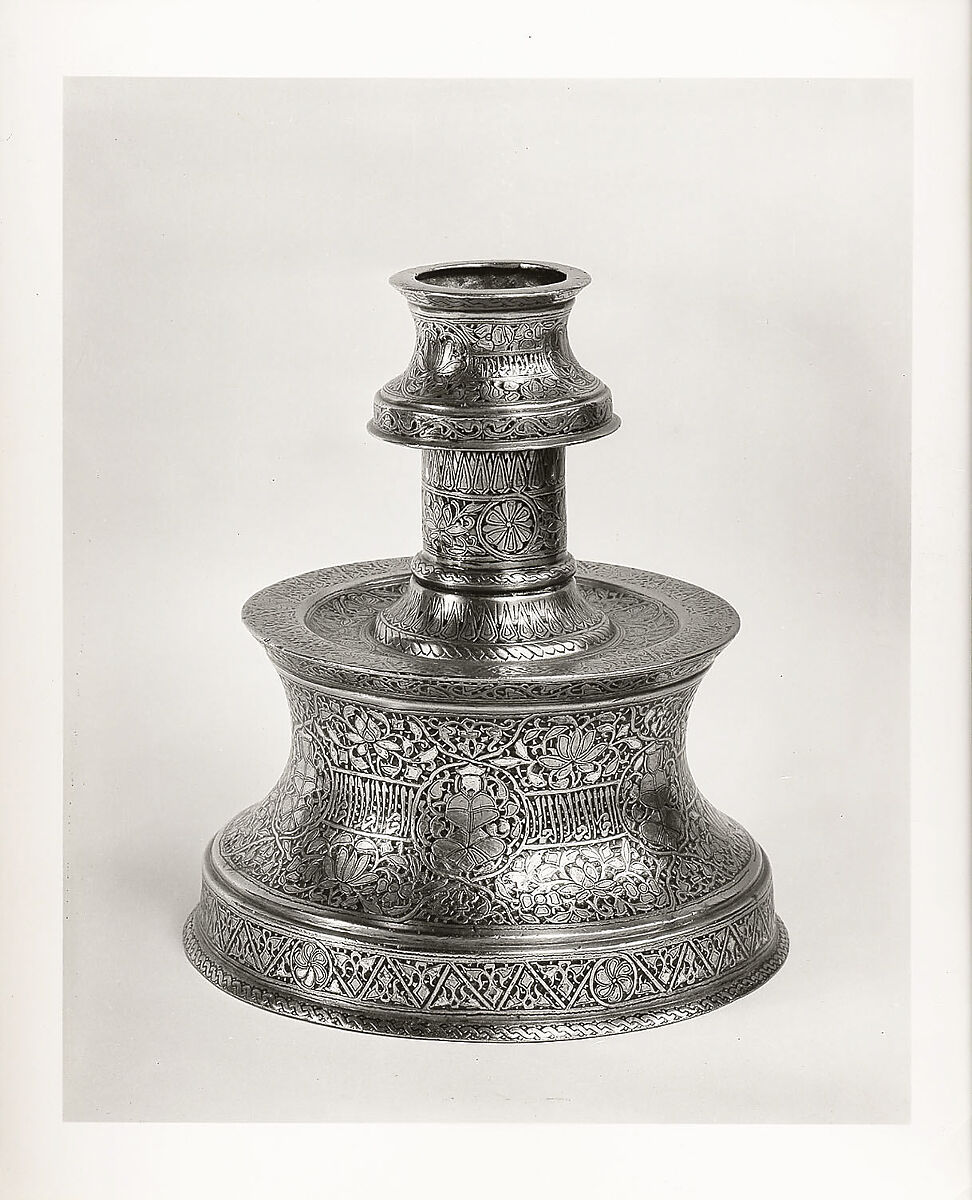 Candlestick with Repeating Seated Figure, Inscription, and Flowers, Brass; cast, engraved, and originally inlaid with silver