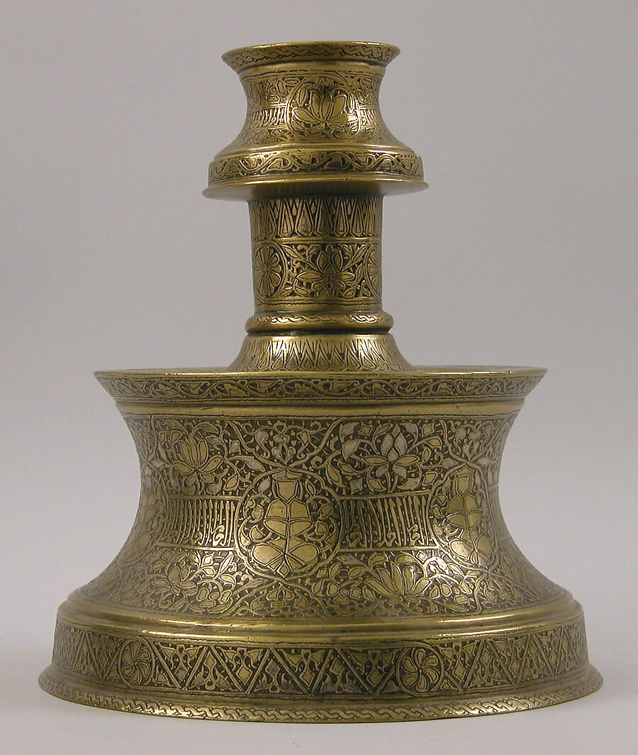 Candlestick with Repeating Seated Figure, Inscription, and Flowers, Brass; cast, engraved, and originally inlaid with silver