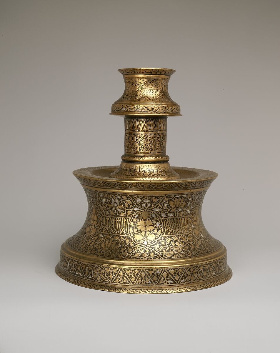 Candlestick with Repeating Seated Figure, Inscription, and Flowers, Brass; cast, engraved, and originally inlaid with silver