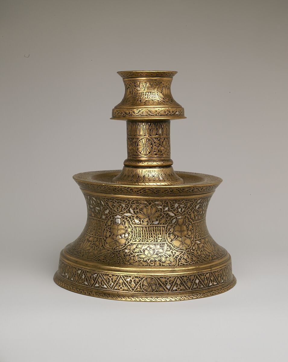 Candlestick with Repeating Seated Figure, Inscription, and Flowers, Brass; cast, engraved, and originally inlaid with silver