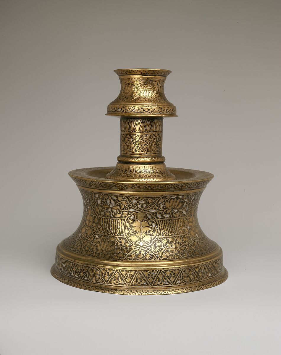 Candlestick with Repeating Seated Figure, Inscription, and Flowers, Brass; cast, engraved, and originally inlaid with silver