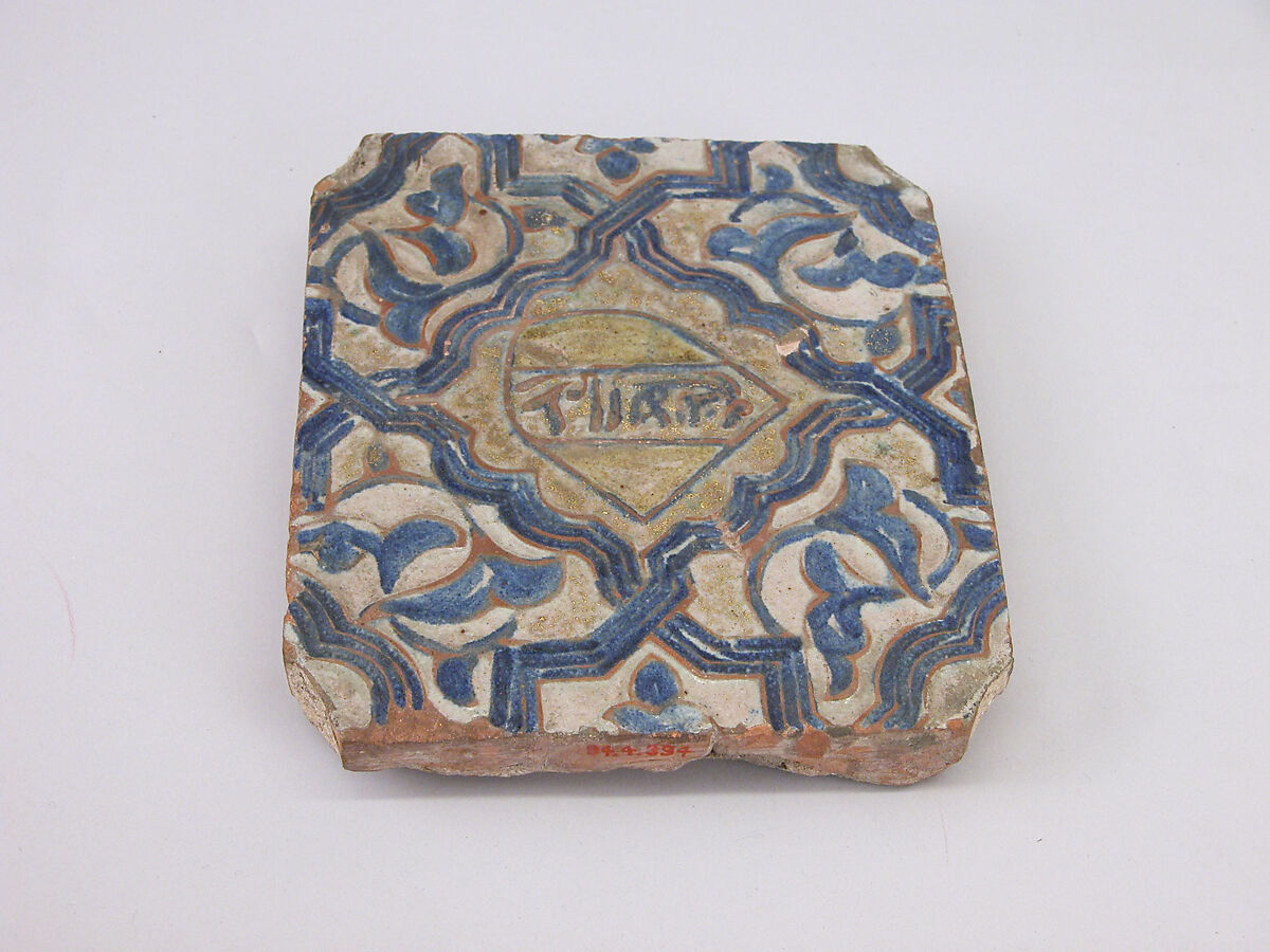 Tile, Earthenware; molded, cobalt-painted on an opaque white glaze powdered with gold under a transparent glaze 