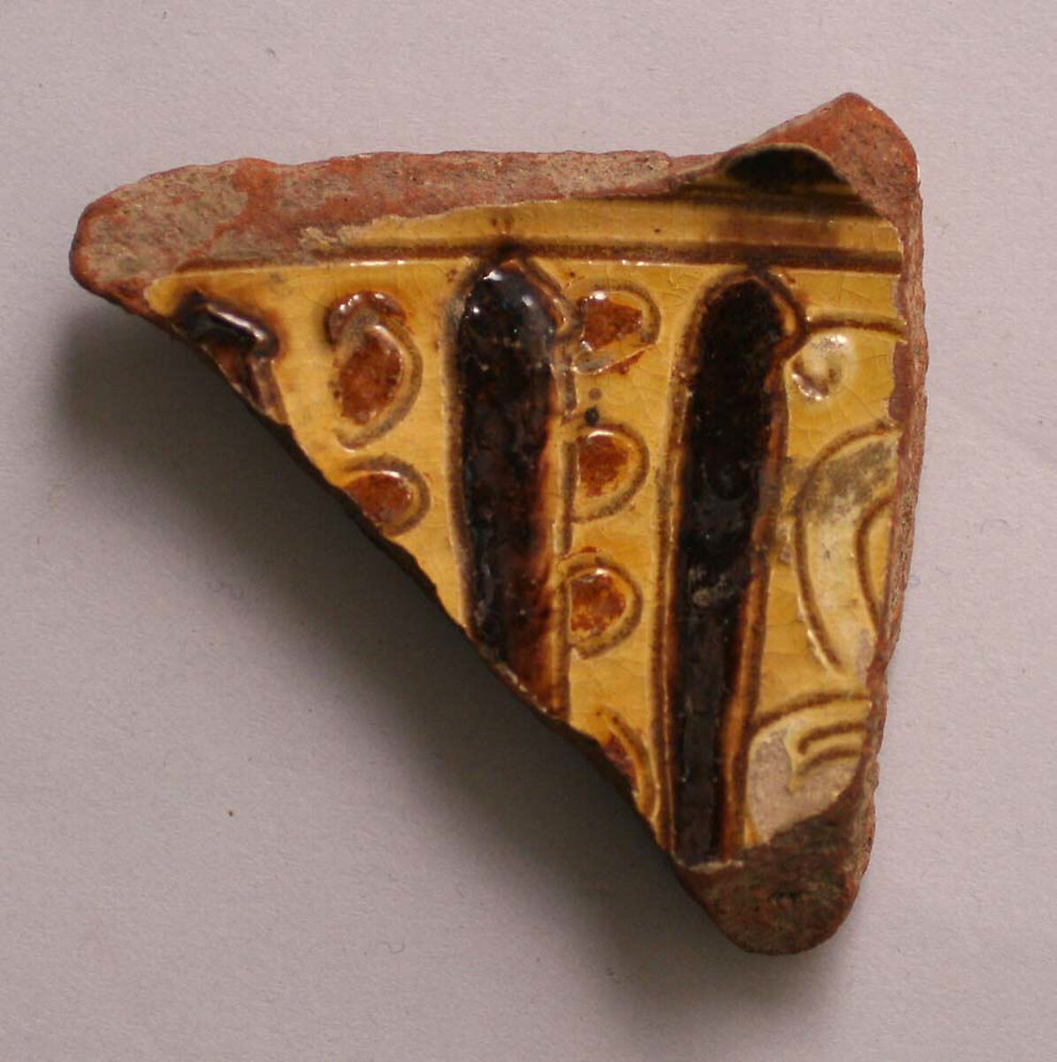 Fragment, Earthenware; incised decoration through a white slip and coloring under transparent glaze. 