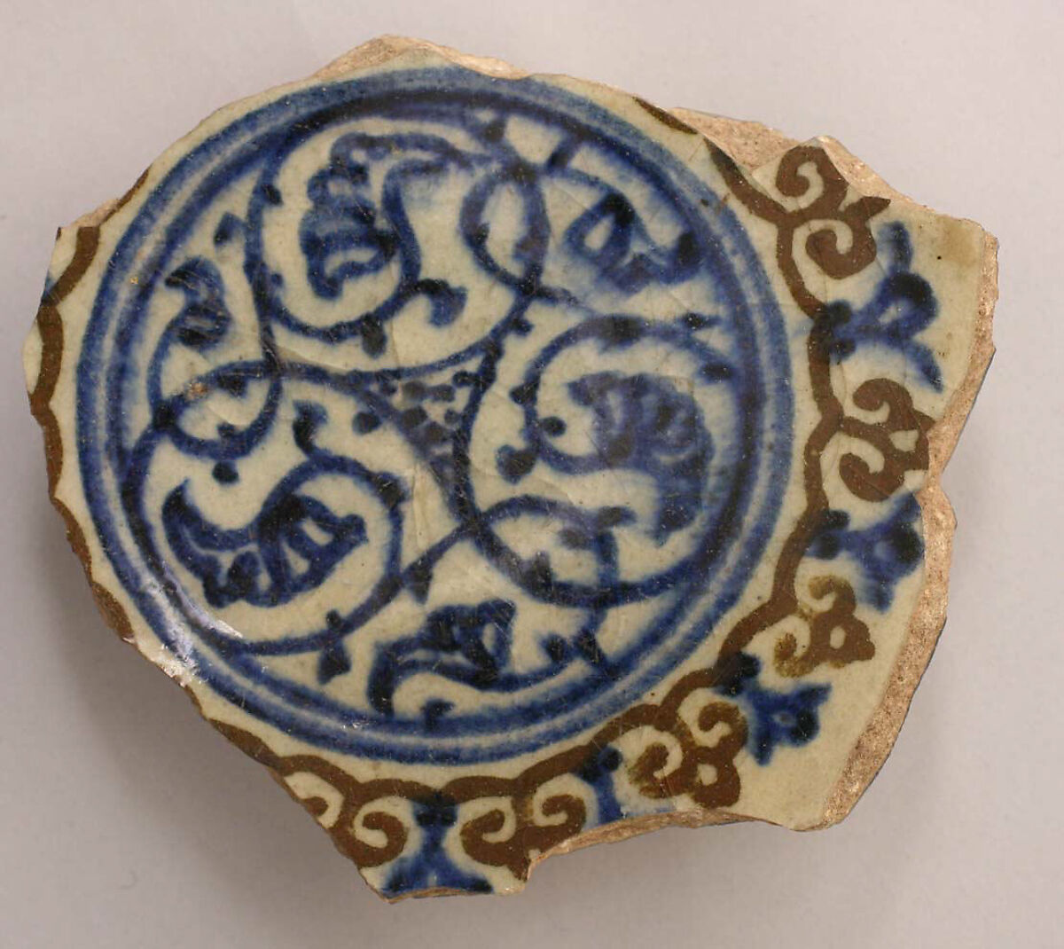 Fragment of a Bowl, Stonepaste; white slip; blue and black underglaze; transparent, colorless glaze 