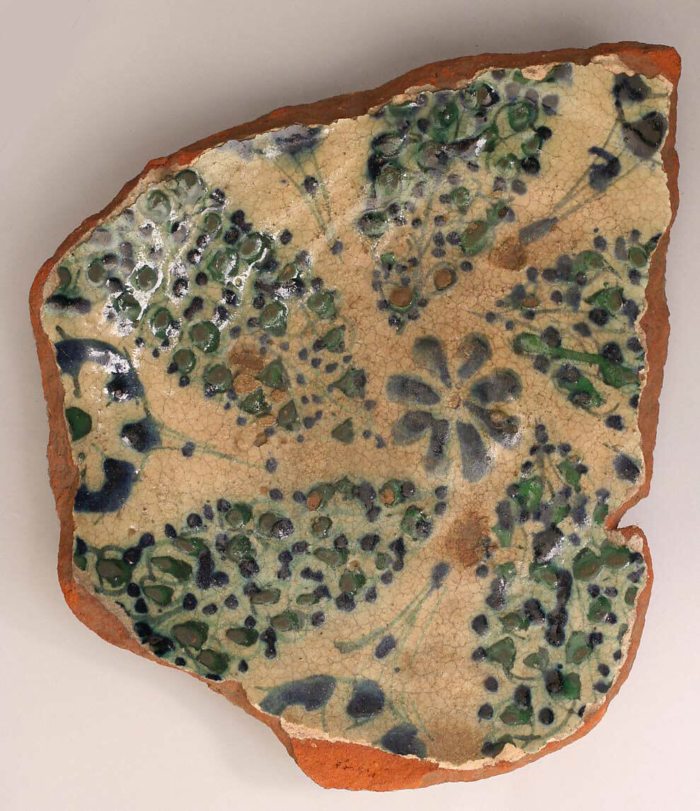 Fragment of a Bowl, reddish earthenware; white slip; green underglaze; transparent colorless glaze 