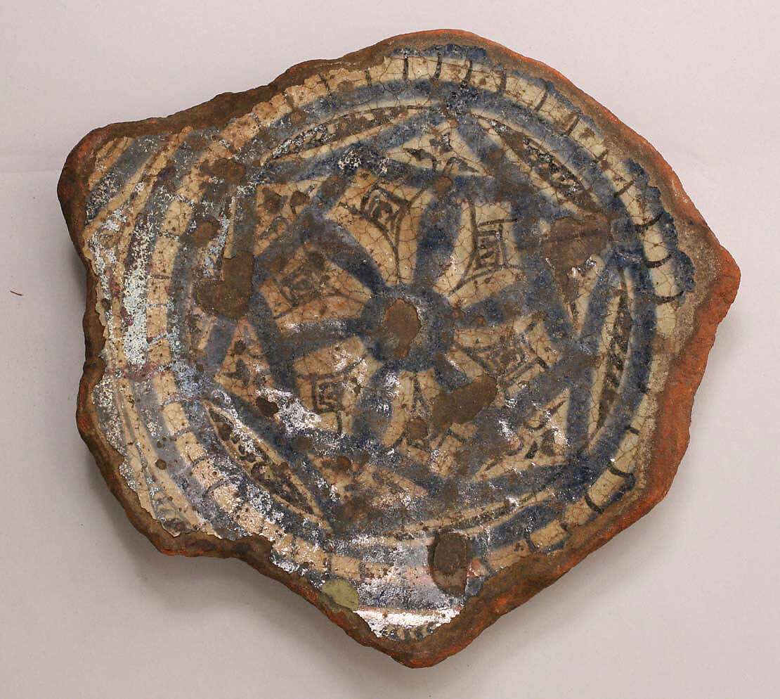 Fragment of a Bowl, reddish earthenware; white slip; blue and black underglaze; transparent, colorless glaze 