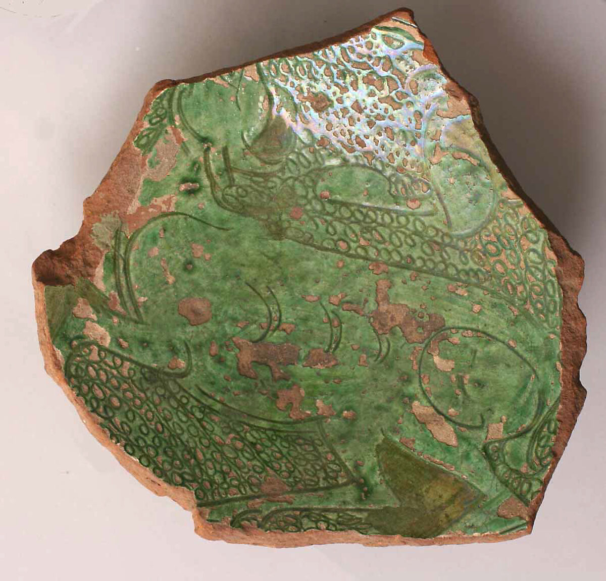 Fragment, Earthenware; incised decoration through white slip and coloring under transparent glaze. 