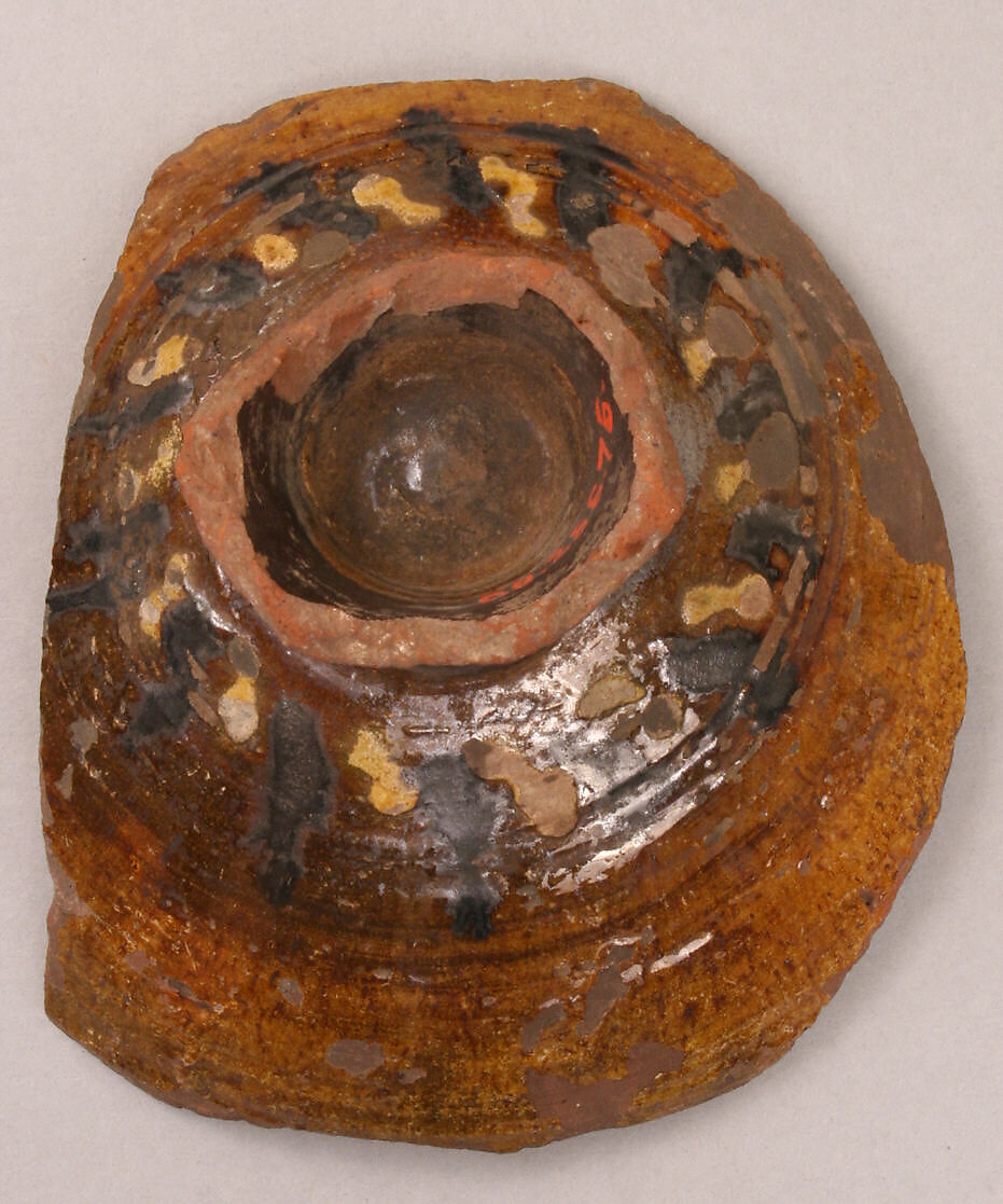 Fragment of a Bowl, reddish earthenware; white slip; green and rust underglaze; transparent glaze