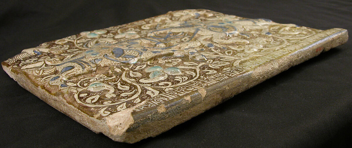 Frieze Tile with Two Hunters, Stonepaste; molded, inglaze painted in blue and turquoise, luster-painted on opaque white glaze