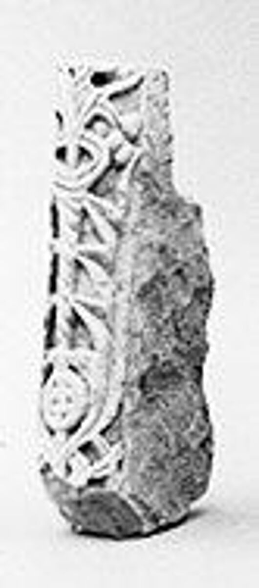 Fragment of Molding with a Vegetal Motif Departing from a Round Element, Limestone; carved in relief 