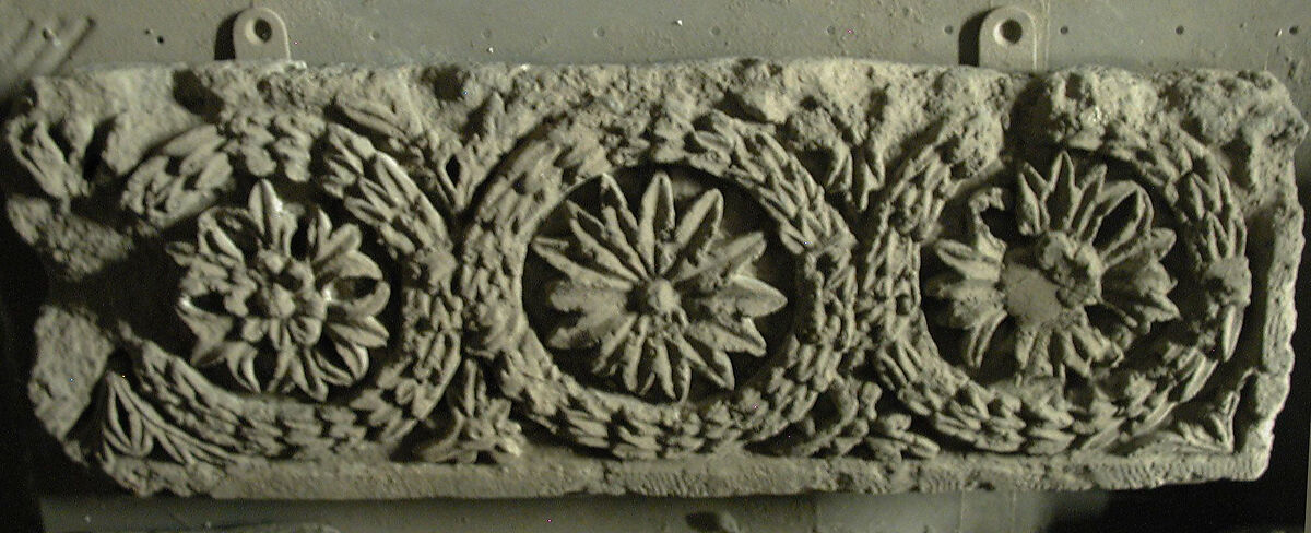 Fragment of a Frieze with a Sequence of Roundels Enclosing Rosettes, Limestone; carved in relief 