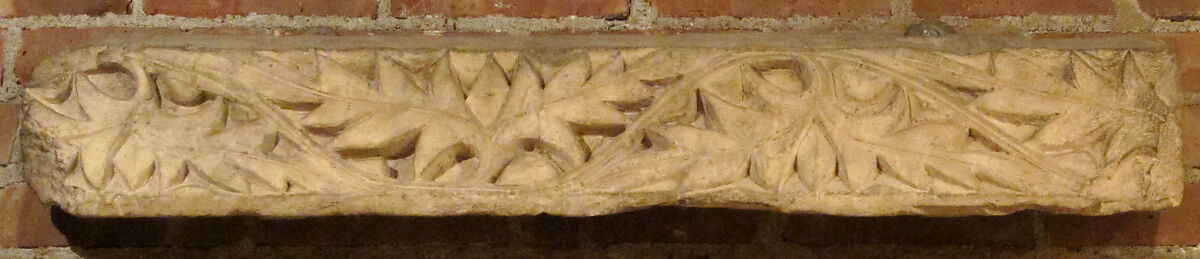 Fragment from a Post or Lintel with Leaves Branching from a Running Vine, Limestone; carved in relief