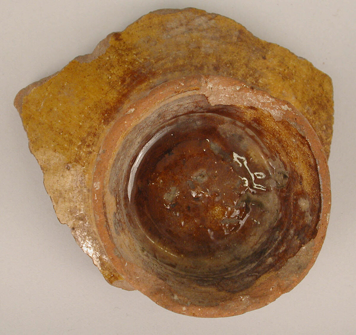Fragment of a Bowl, Earthenware; incised decoration through white slip and coloring under transparent glaze.
