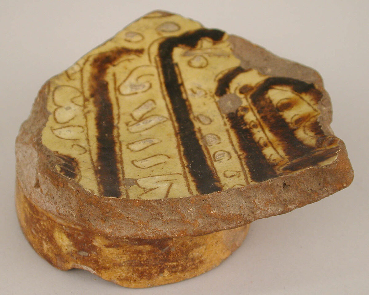 Fragment of a Bowl, Earthenware; incised decoration through white slip and coloring under transparent glaze.