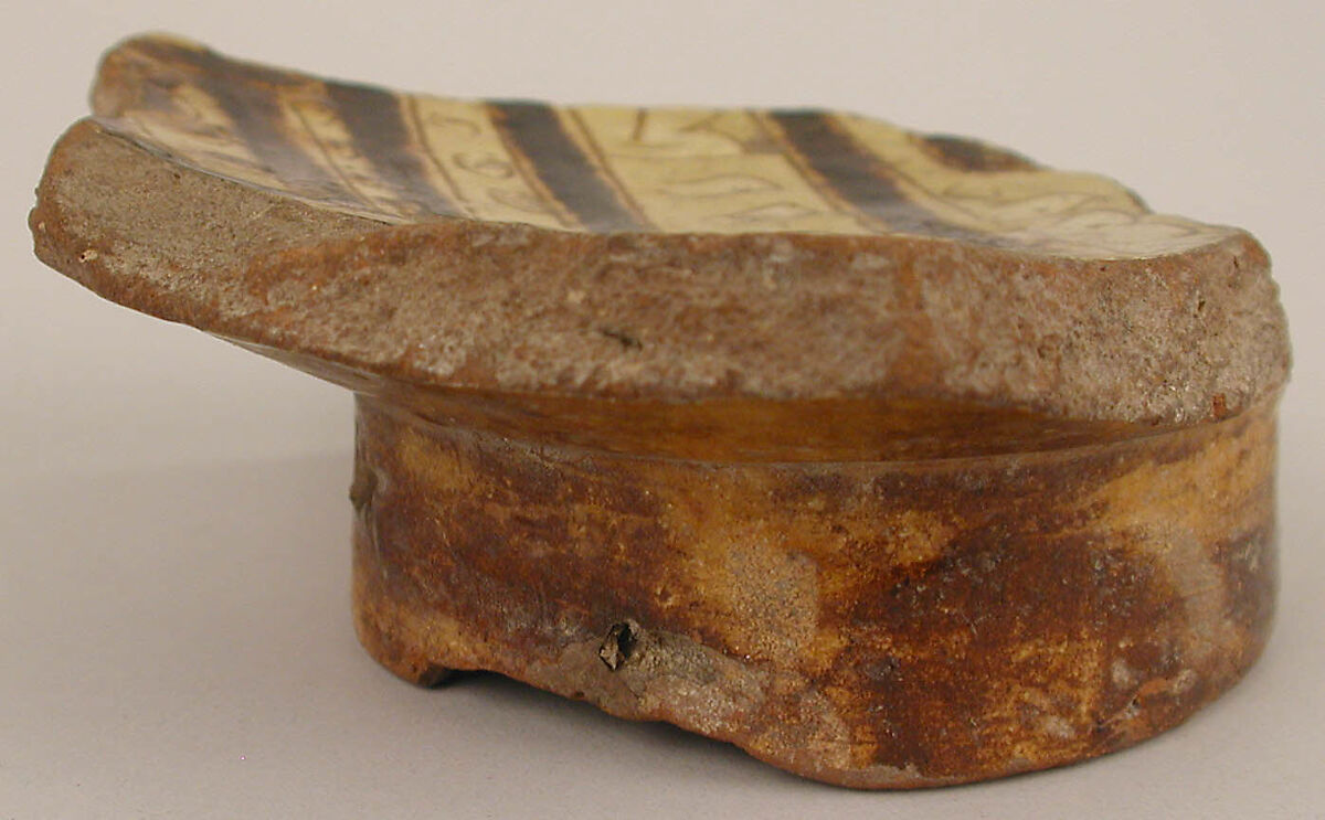 Fragment of a Bowl, Earthenware; incised decoration through white slip and coloring under transparent glaze.