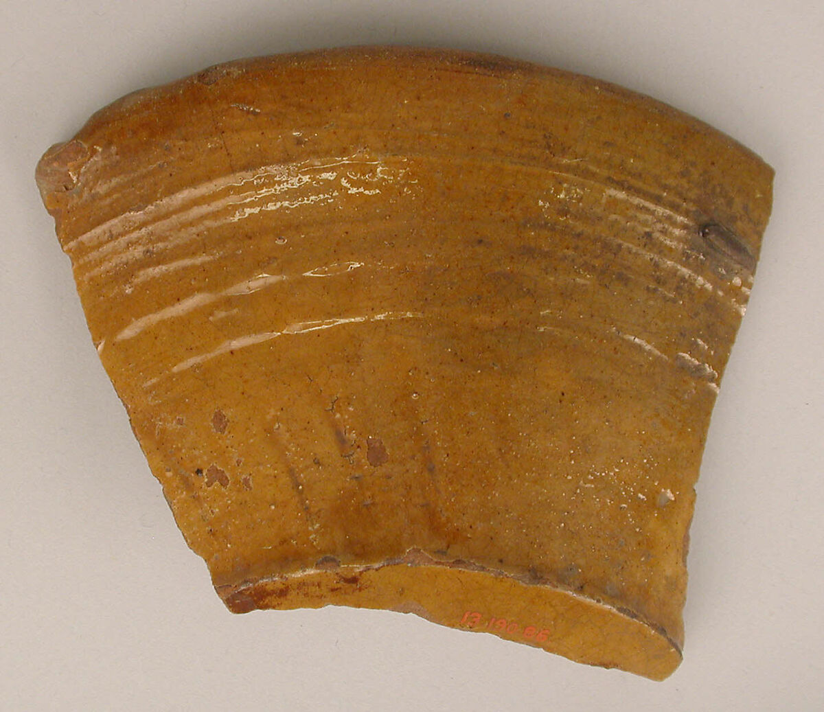 Fragment of a Bowl, Earthenware; incised decoration through white slip and coloring under transparent glaze