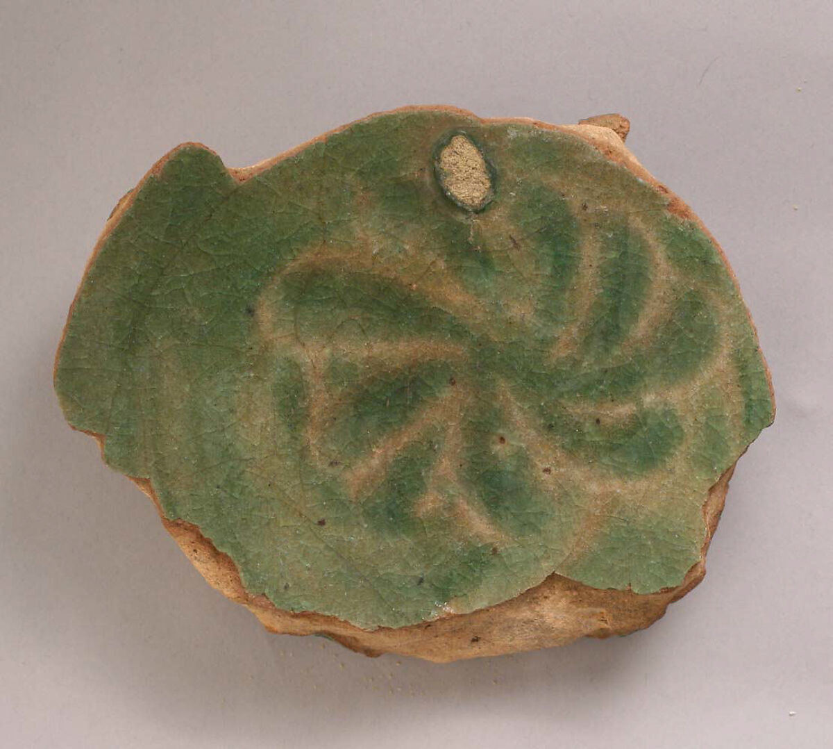 Fragment of a Bowl, Earthenware; modeled decoration under transparent green glaze 