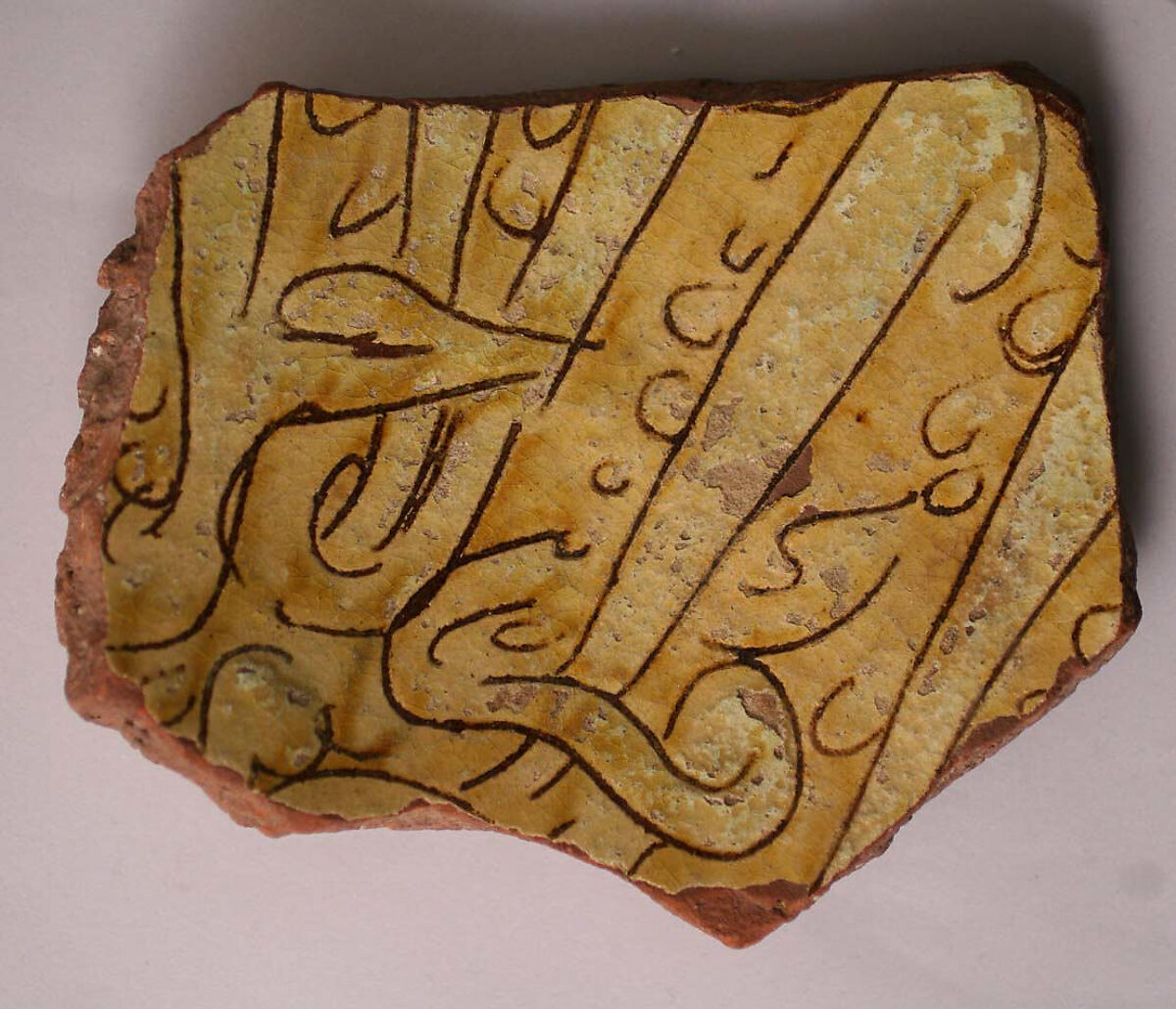 Ceramic Fragment, Earthenware; incised decoration through white slip and coloring under transparent glaze. 