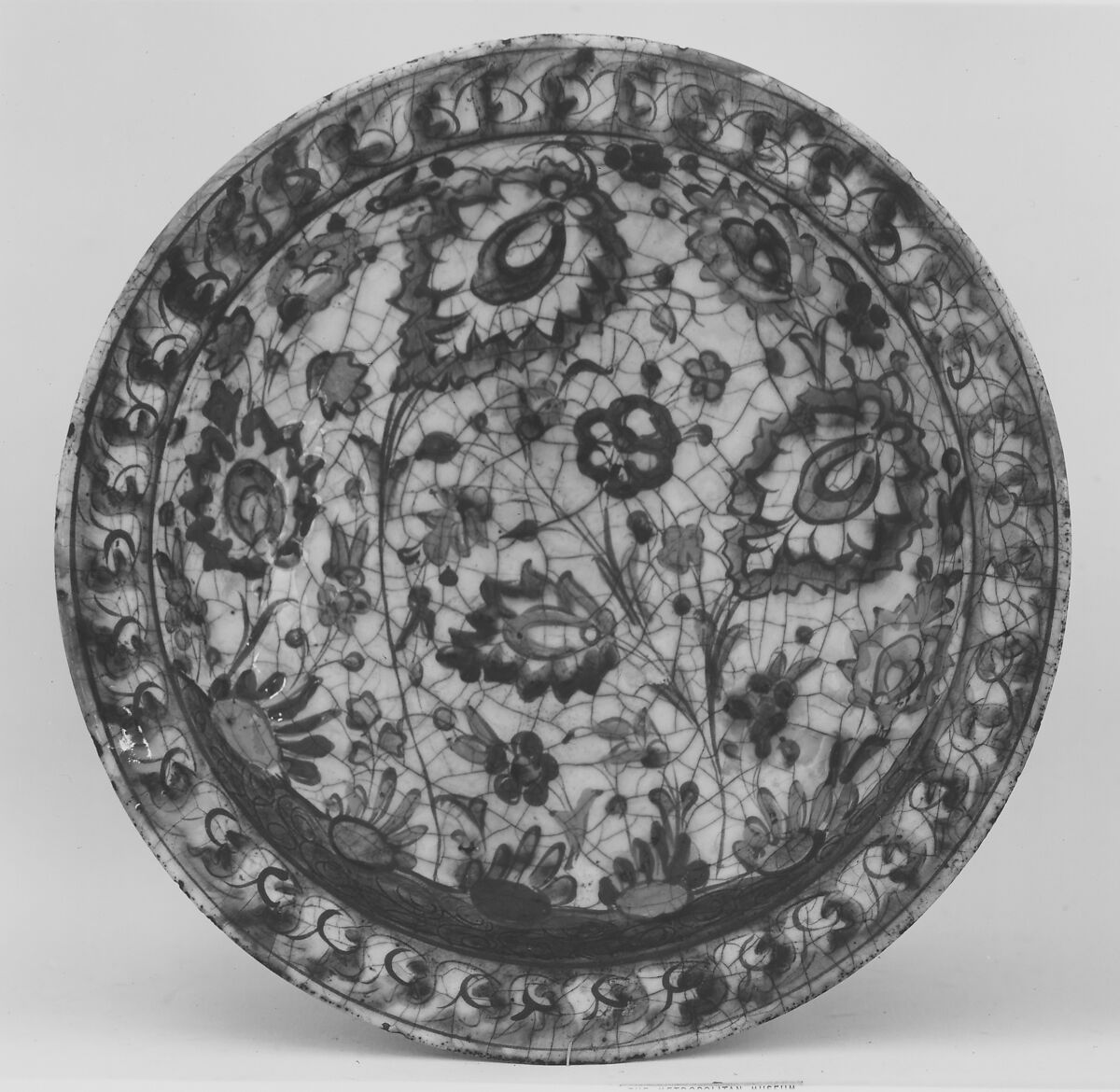 Dish, Stonepaste; underglaze painted in black, blue, and green with red and yellow slips