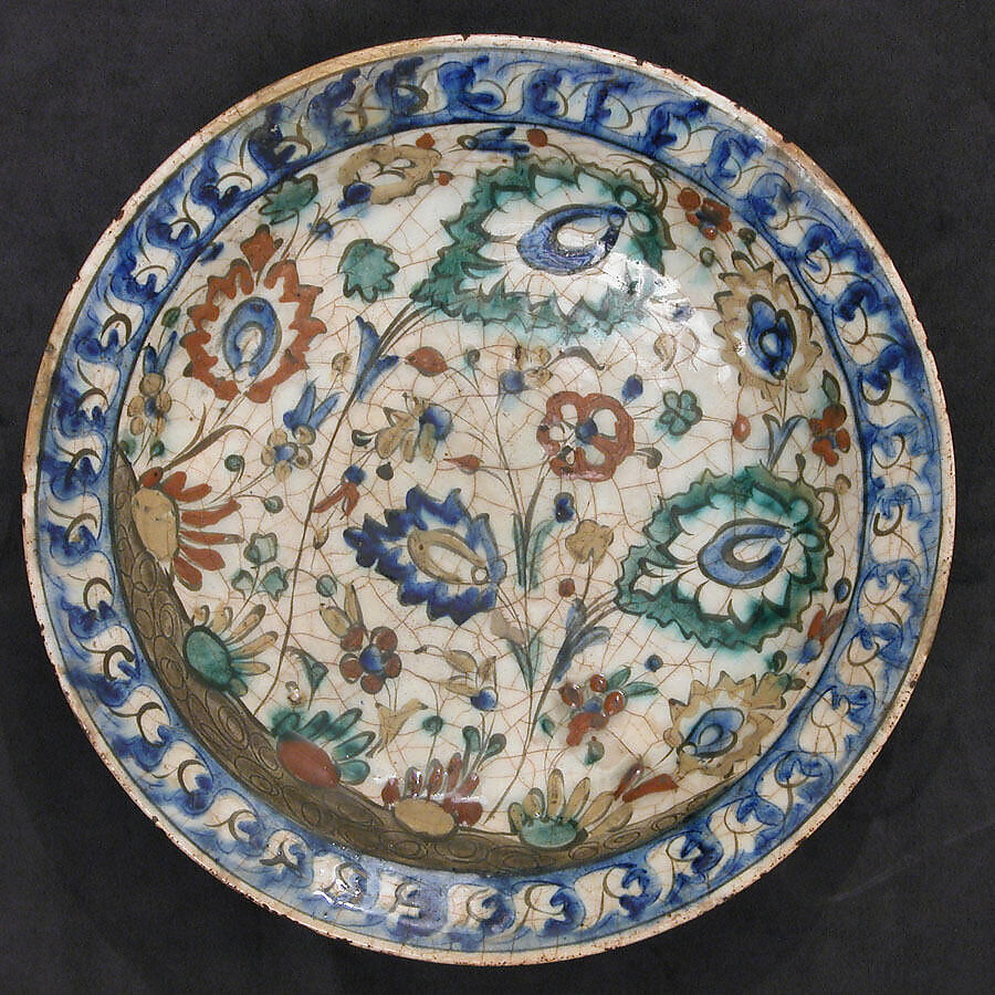 Dish, Stonepaste; underglaze painted in black, blue, and green with red and yellow slips 