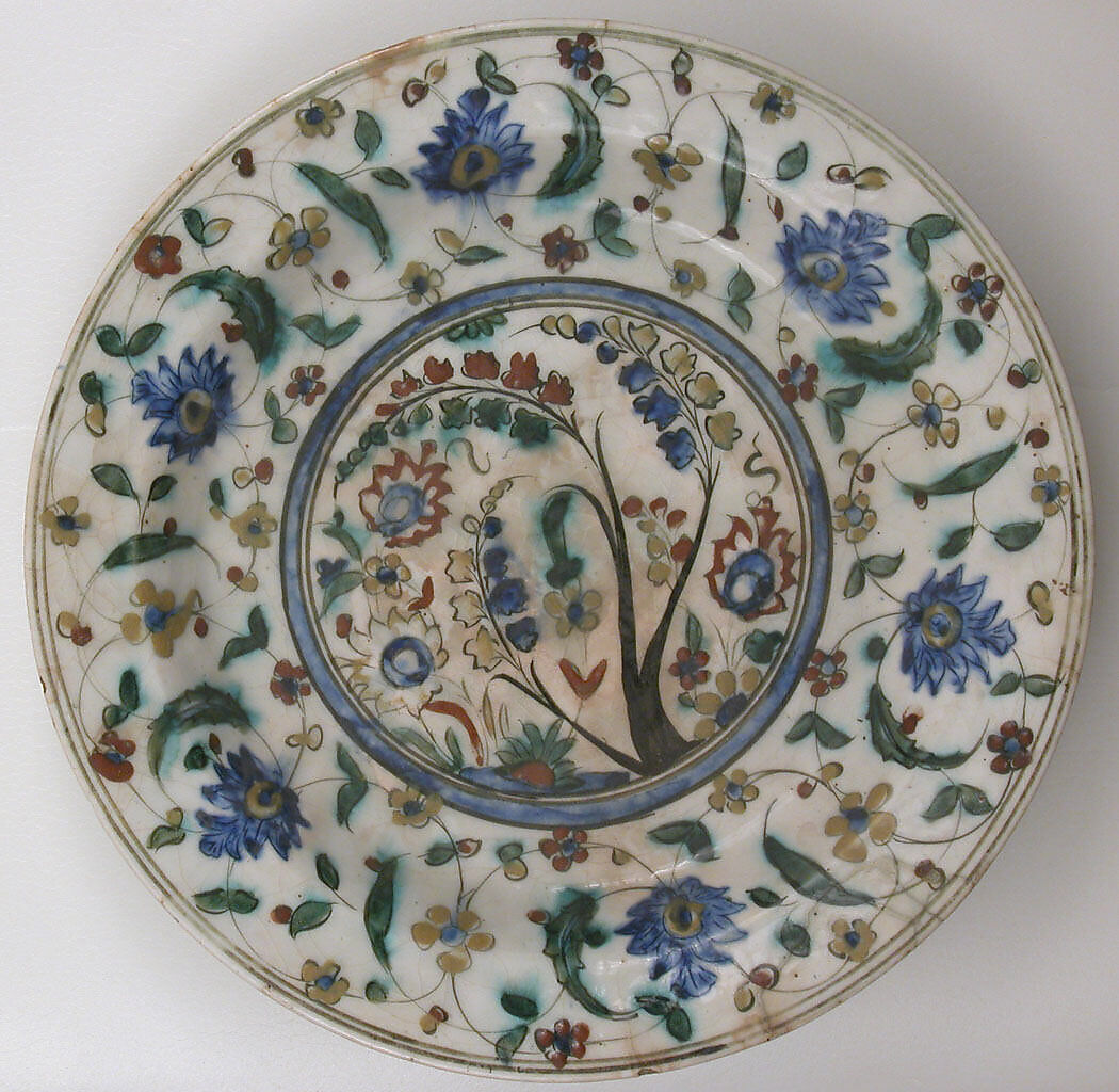 Plate, Stonepaste; underglaze painted in black, blue, and green with red and yellow slips 