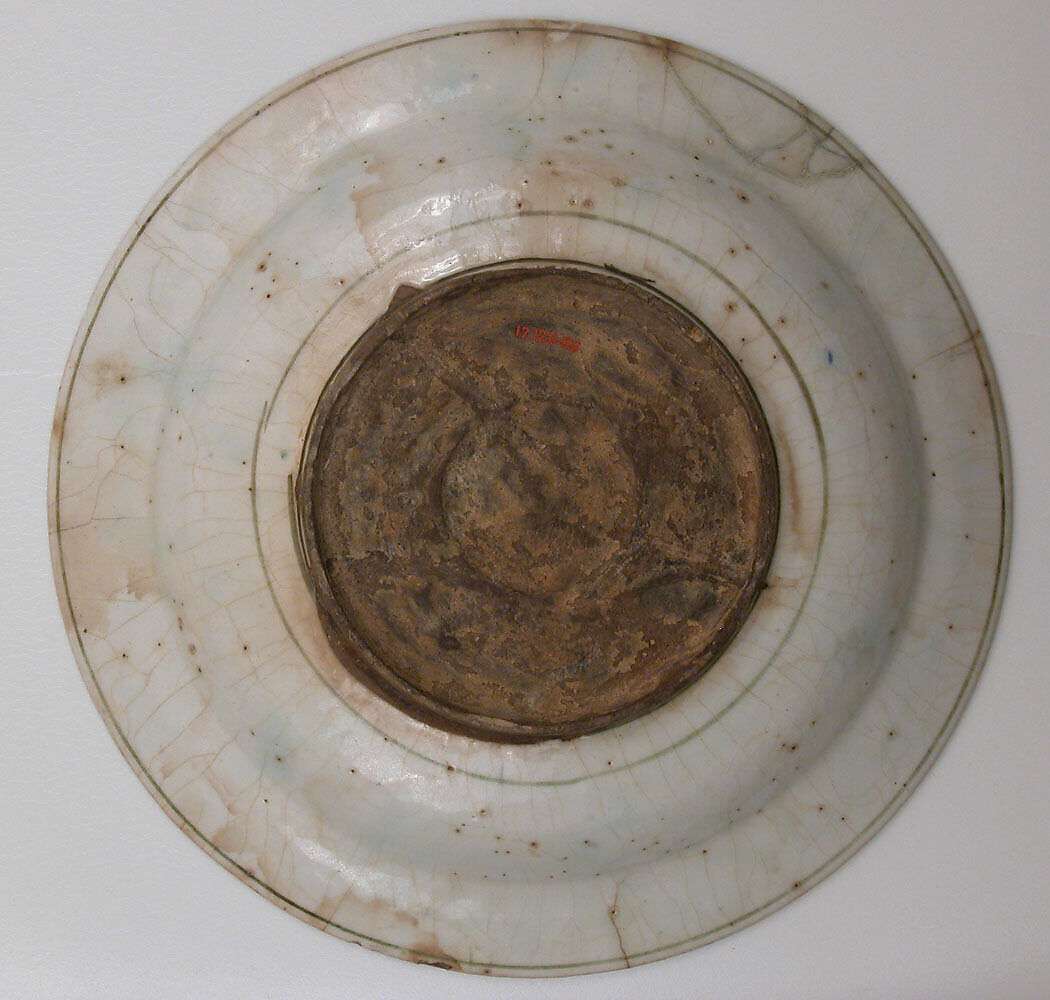 Plate, Stonepaste; underglaze painted in black, blue, and green with red and yellow slips