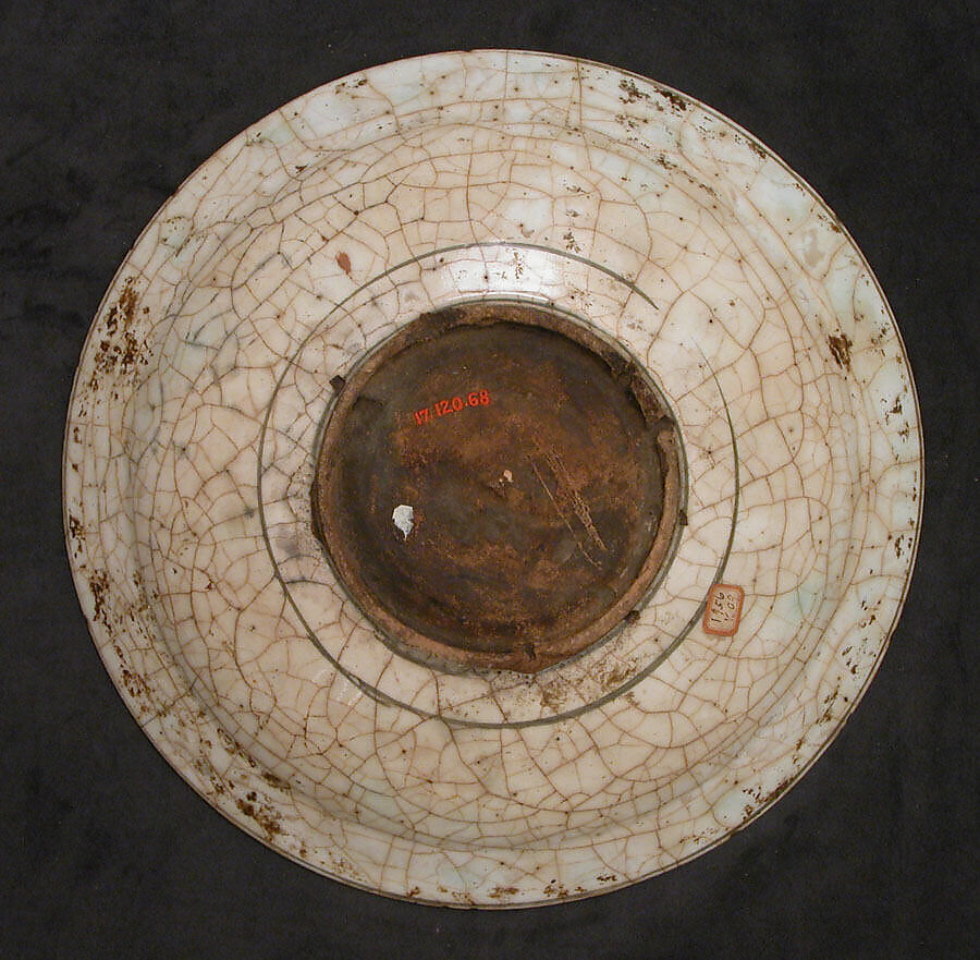 Dish, Stonepaste; underglaze painted in black, blue, and green with red and yellow slips