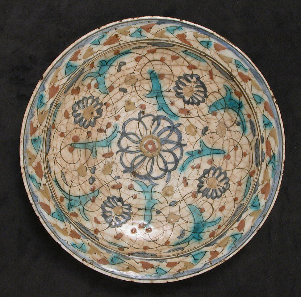 Dish, Stonepaste; underglaze painted in black, blue, and green with red and yellow slips 