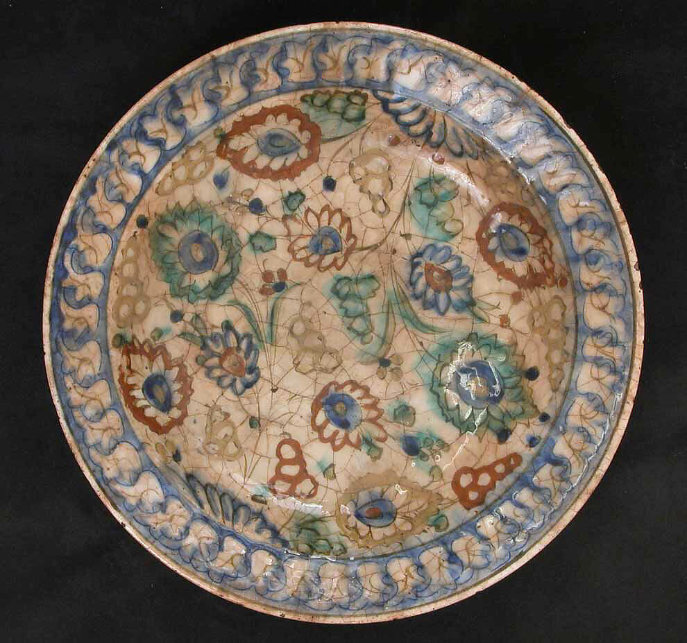 Dish, Stonepaste; underglaze painted in black, blue, and green with red and yellow slips 