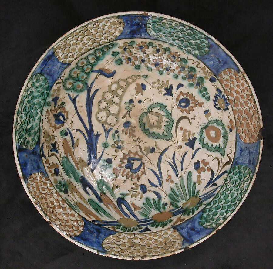 Dish, Stonepaste; underglaze painted in black, blue, and green with red and yellow slips 