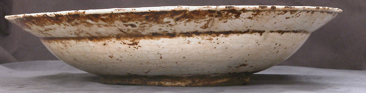 Dish, Stonepaste; underglaze painted in black, blue, and green with red and yellow slips