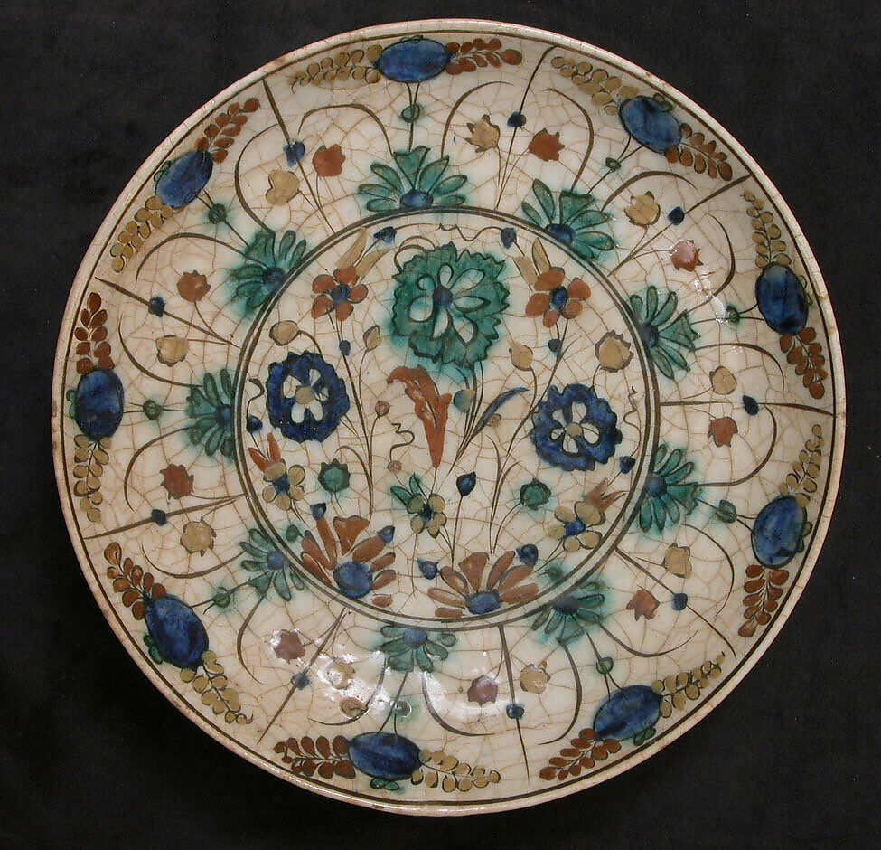 Dish, Stonepaste; underglaze painted in black, blue, and green with red and yellow slips 