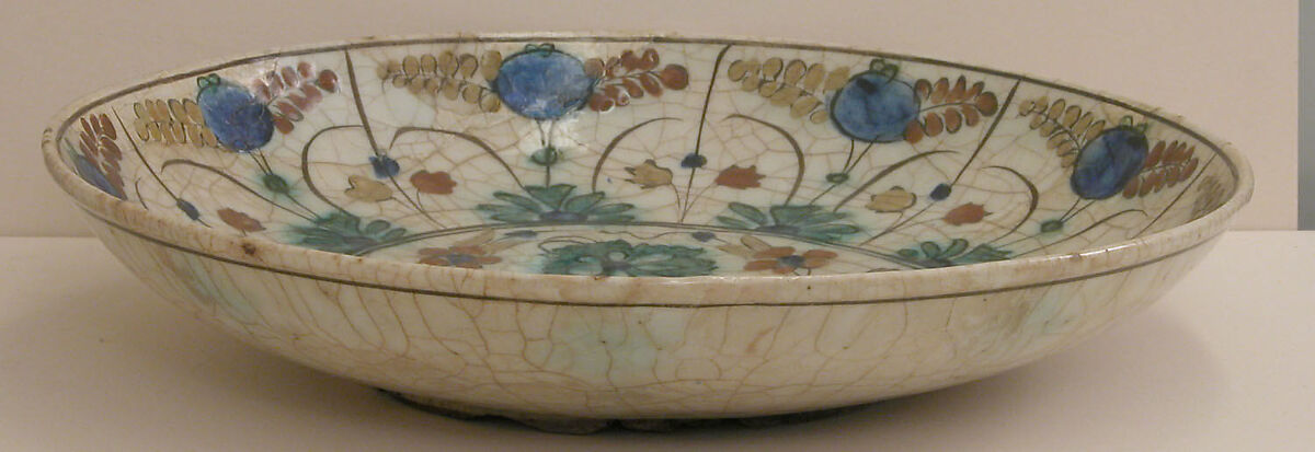 Dish, Stonepaste; underglaze painted in black, blue, and green with red and yellow slips