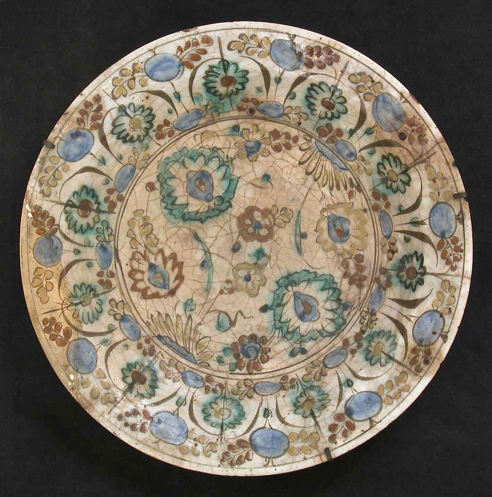 Dish, Stonepaste; underglaze painted in black, blue, and green with red and yellow slips 