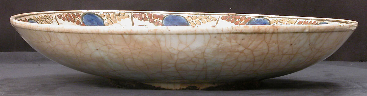 Dish, Stonepaste; underglaze painted in black, blue, and green with red and yellow slips