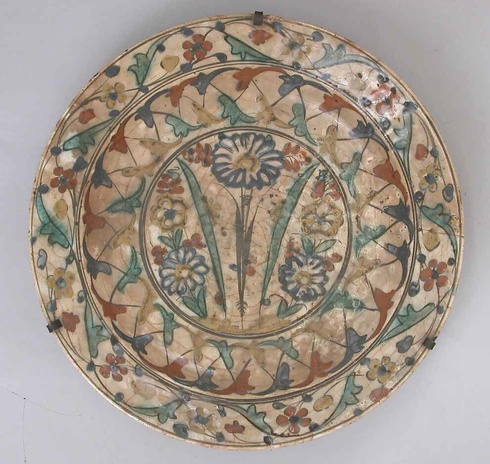 Dish, Stonepaste; underglaze painted in black, blue, and green with red and yellow slips 