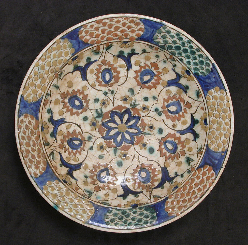 Dish, Stonepaste; underglaze painted in black, blue, and green with red and yellow slips 