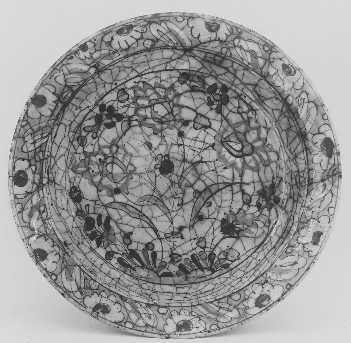 Dish, Stonepaste; underglaze painted in black, blue, and green with red and yellow slips
