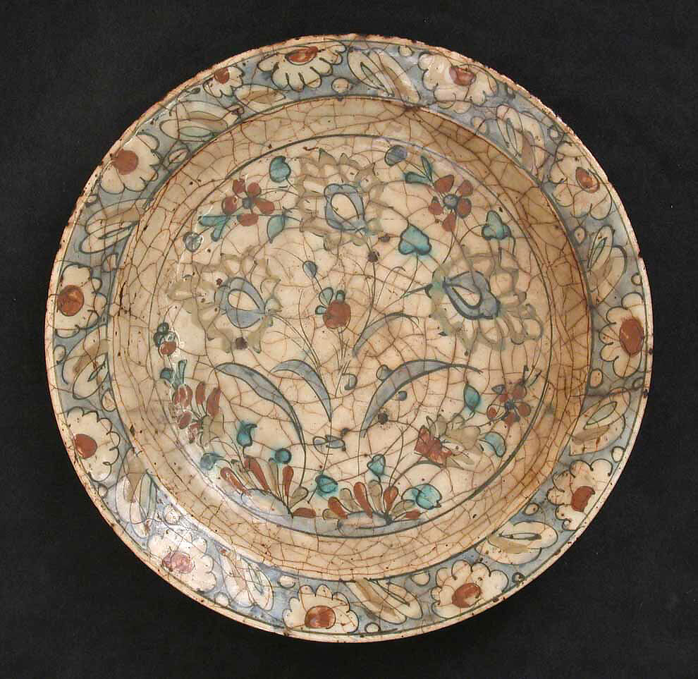 Dish, Stonepaste; underglaze painted in black, blue, and green with red and yellow slips 